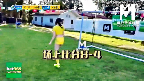 Asian cheerleader in tight yellow outfit on soccer field, teasing pose