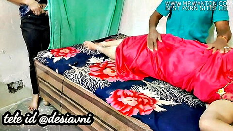 Indian woman in red sari groped by two men on bed in steamy threesome tease