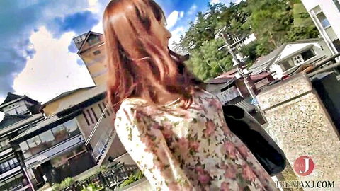 Asian woman in floral dress strolling by hot springs, teasing outdoor JAV adventure