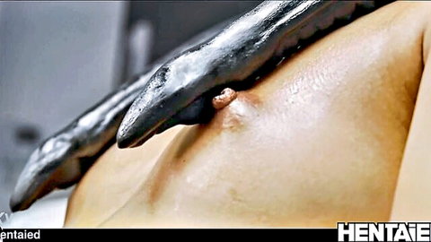 Black tentacle suction cup latched onto fair-skinned girl's erect pink nipple closeup