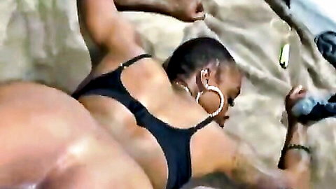 Thick ebony babe in black bikini top, big ass exposed, arms raised seductively