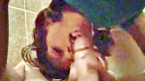 Ebony woman on knees giving intense blowjob in steamy scene