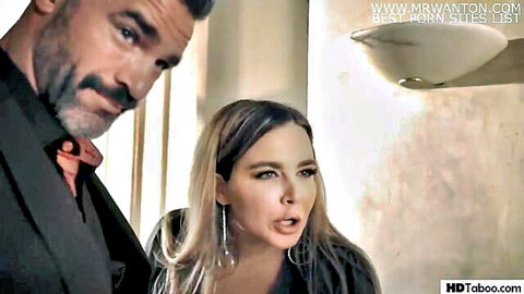 Muscular bearded man in suit stares intensely at surprised blonde woman with open mouth in taboo scene