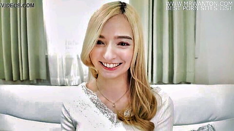 Smiling blonde Karina Nishida in sequined white top, JAV solo portrait