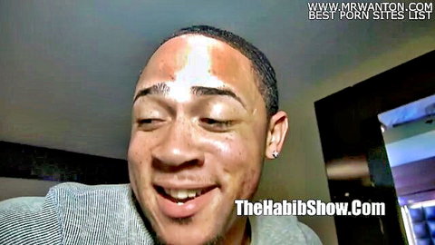 Smiling black man with earrings in gray shirt closeup from TheHabibShow