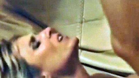 Blonde woman's ecstatic open-mouth O-face during intense pleasure closeup