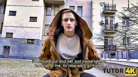 Young hooded man outdoors heading to familiar tutor's place in Tutor4K video