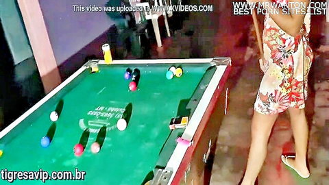 Curvy woman in floral dress by pool table in cabaret threesome scene