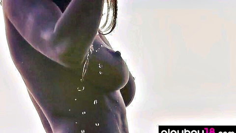 Closeup of wet big tits with water droplets dripping from erect nipples