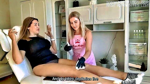 Blonde waxing sexy brunette's long legs in bikini depilation session