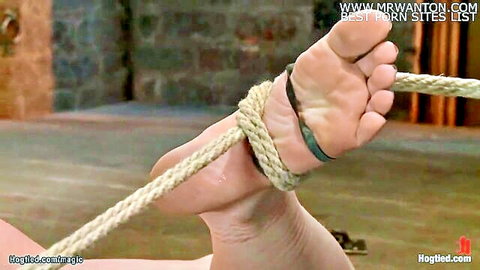 Hogtied lesbian bound in ropes with butt plug, foot and ankle focus