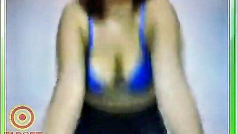 Latina woman in blue bikini top showing deep cleavage