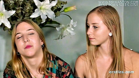 Two blonde women in intimate embrace, one nude, Ersties studio