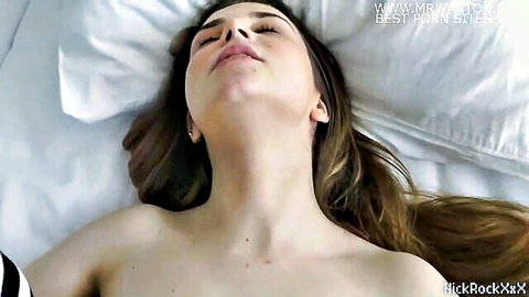 Topless skinny brunette teen babe with small tits and glasses lying ecstatic on bed
