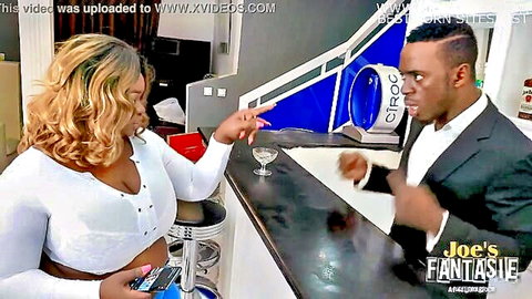Curvy ebony BBW waitress with huge tits flirts with suited black guy at bar holding champagne