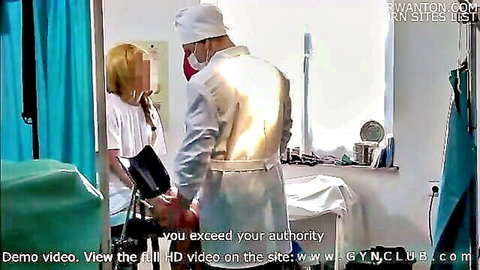 Doctor in surgical mask examines blonde patient arm in hospital medical fetish scene