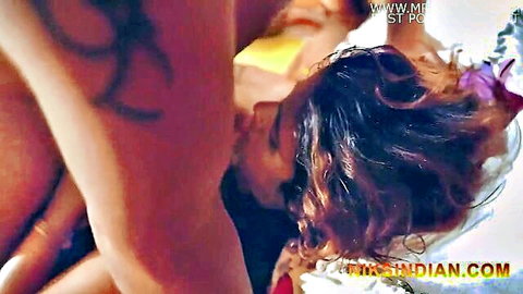 Busty Indian woman in rough passionate kiss with tattooed muscular man grabbing her neck