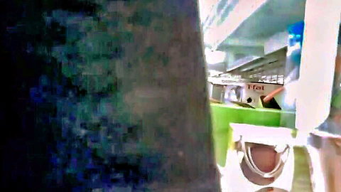 Blurry amateur view of empty public mall escalator area with green walls