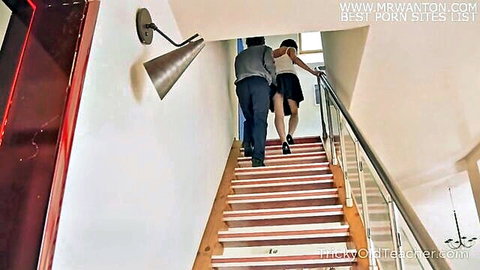 Naughty brunette in short skirt teases tricky old teacher up the stairs