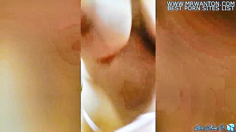 Blurry closeup of nude woman's pale breasts and skin with heavy watermarks overlay