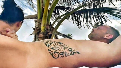 Brunette leans over tattooed Dorian Del Isla on Tulum beach