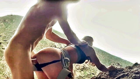 Outdoor rock climbing sex adventure with harnessed blonde in doggy style