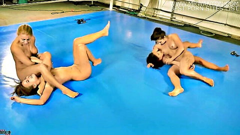 Four nude women in intense catfight wrestling with foot fetish on blue mat
