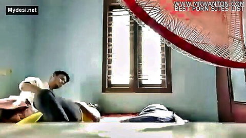 Indian man lounging on bed with woman in casual attire