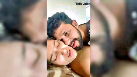 Desi Indian couple in passionate bedroom embrace