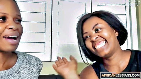 Two smiling ebony lesbians laughing intimately together