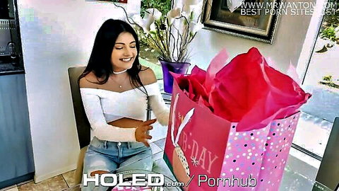 Adria Rae smiling with birthday gift in white off-shoulder top and jeans