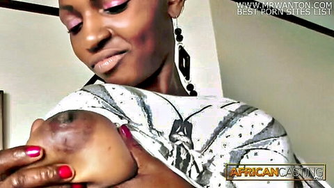 Ebony woman squeezing her big natural tits with red nails exposing nipple