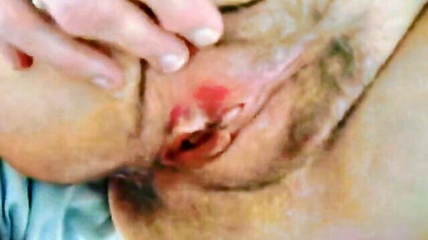 Close-up of naughty wife's hairy pussy with red swollen labia and hand tease