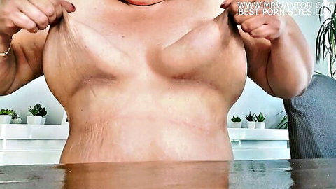Curvy woman stretching her large nipples and big breasts