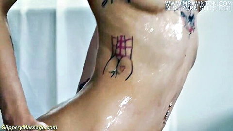 Wet skinny tattooed teen posing nude in slippery massage scene