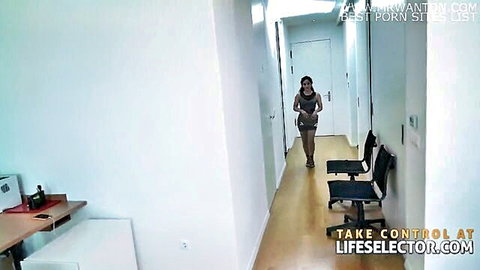 Brunette secretary in tight mini dress struts down office hallway teasing her curves