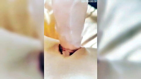 Blurry closeup of amateur French babe's shaved wet pussy lips exposed amid white fabric sheets