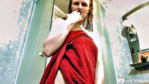 Wet redhead MILF in red towel, ready to strip and masturbate passionately