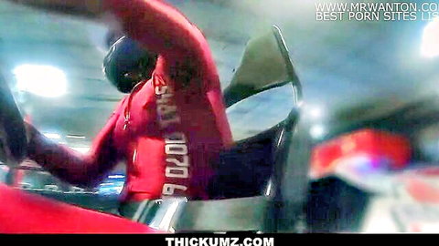 Man in red hoodie drives car at night with Thickumz porn watermarks