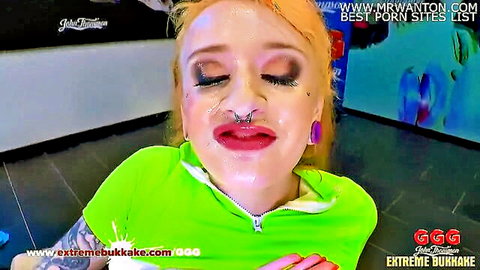 Pierced redhead with heavy makeup pouting seductively in green top for extreme bukkake