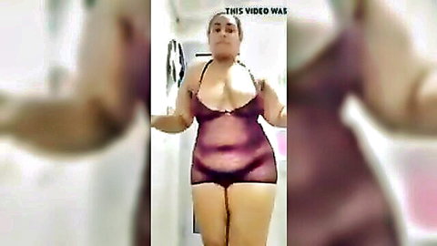Curvy Arab woman in sheer purple lingerie teasing big tits and pussy mound in bathroom