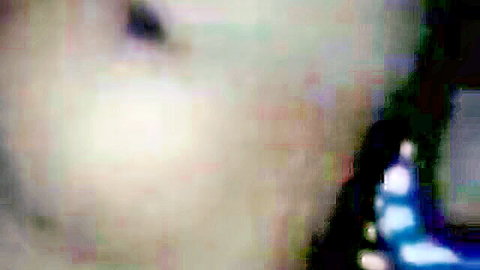 Blurry close-up of woman's open mouth near dark shaft in intense oral action