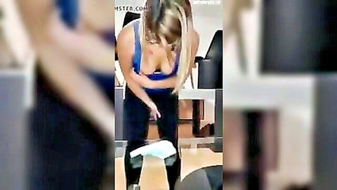 Blonde with huge tits spilling from tight blue tank top bends over in black leggings showing deep cleavage