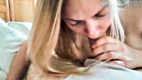 Blonde babe jerks off cock on bed, her tits shaking intensely