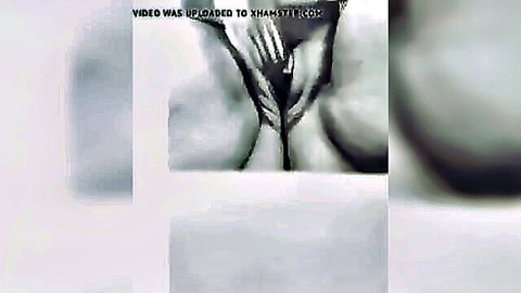 Blurry closeup of massive tits squeezed tightly by hands