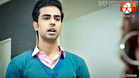 Surprised handsome Indian man in teal sweater and pink shirt in office setting