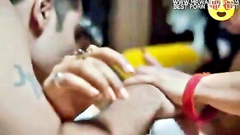 Indian woman in yellow saree giving handjob to man, close-up on jeweled hands