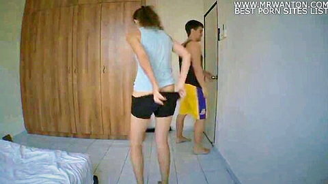 Amateur couple in funny pantsing game, girl in shorts bending over for prank