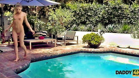 Slim blonde nympho nude by pool in Daddy4K outdoor daddy scene