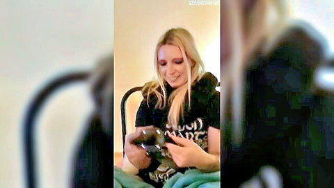 Blonde gamer girl smiling with controller in casual black t-shirt